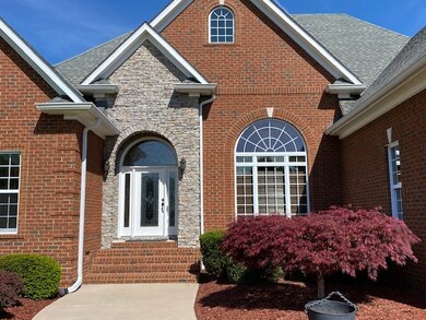 The elegant entry features an arched stone vestibule.