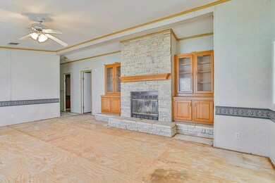 Large main living space once you walk into the home with a wood burning stone fireplace.