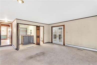 The expansive family room features glass doors lea