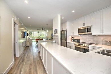 Kitchen featuring open floor plan, tasteful backsp