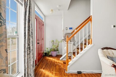 Foyer with stairs, chair lift and wood laminate fl