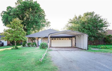 Front of home with 2 car garage plus large carport