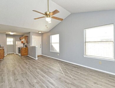 Unfurnished living room featuring a ceiling fan, 