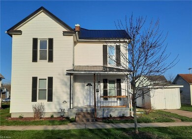 Front of home with storage building