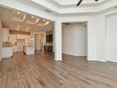 Unfurnished living room with visible vents, wood 
