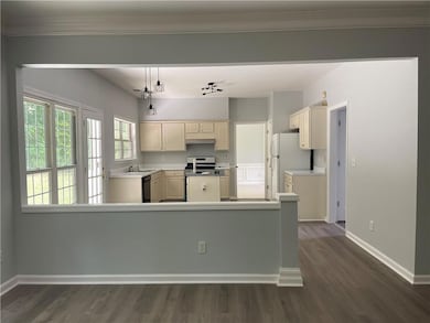 Kitchen with freestanding refrigerator, dark wood-