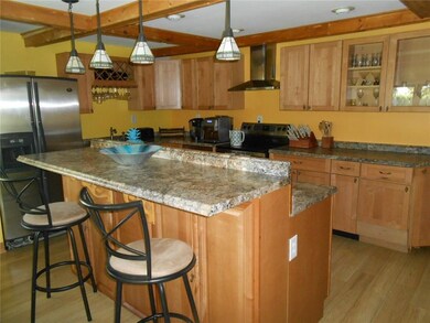 The breakfast bar at the large island in the kitch
