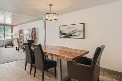 Carpeted dining room featuring a chandelier