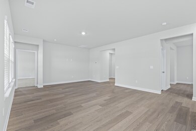 Empty room with light hardwood / wood-style floori