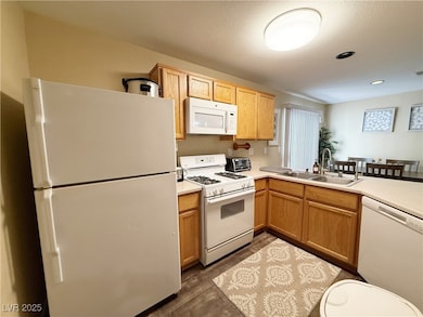 Kitchen with white appliances, dark wood finished