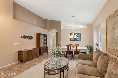 Arched opening leads to kitchen