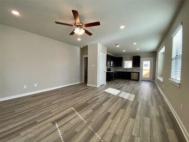 Unfurnished living room with a ceiling fan, wood 