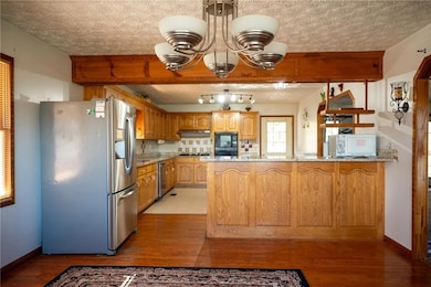 Kitchen with decorative backsplash, light wood-typ