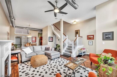 Living room with dark wood-type flooring and ceiling fan