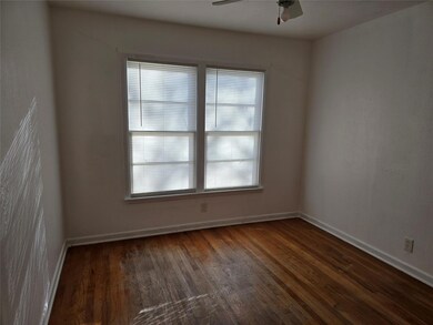 Empty room with ceiling fan and dark hardwood / wo