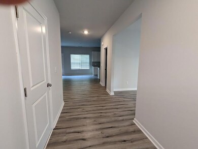Corridor featuring baseboards and dark wood finish