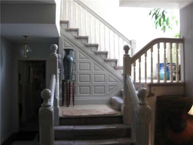 Entry/Foyer. Original woodwork staircase.