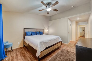 Bedroom featuring light wood finished floors, base