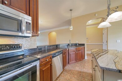 Stainless steel appliances and tile backsplash.