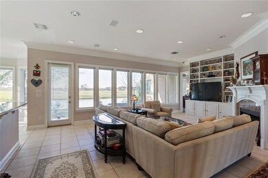LIVING ROOM WITH LARGE WINDOWS OVERLOOKING THE LAG