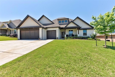 Craftsman-style house with an attached garage, driveway, a front yard, and a shingled roof