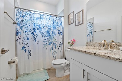 Bathroom with tile patterned flooring, vanity, toi