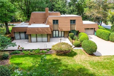 Spacious, outdoor patio deck with mature landscapi