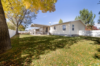 Back of house featuring a patio area, a fenced backyard, and crawl space