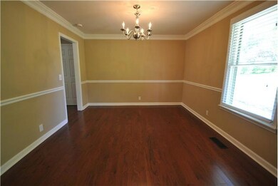 Beautiful chandelier and crown molding make this dining room a popular hangout spot for families. It has access to the living area and kitchen.  