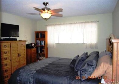 Spacious master bedroom with beautiful ceiling fan