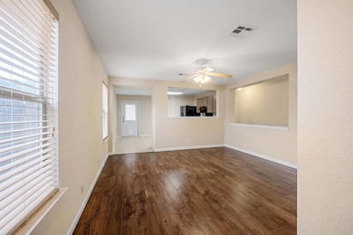 Unfurnished living room featuring wood finished f