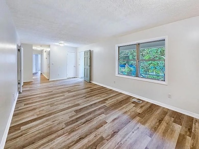 Empty room featuring light wood-style flooring and baseboards