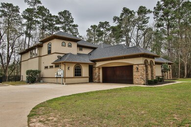 A side view of the house. The beautiful wood 2 car garage doors stand out on this amazing house. Look for the details in this house!