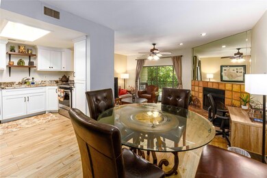 Dining room featuring a fireplace, light wood fin