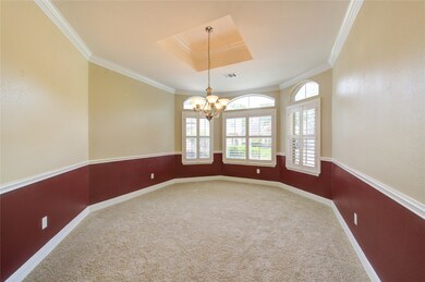 Dining room has crown molding, chair railing and a