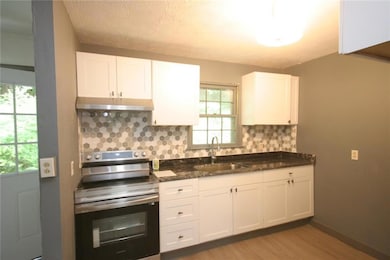 Kitchen with decorative backsplash, stainless stee