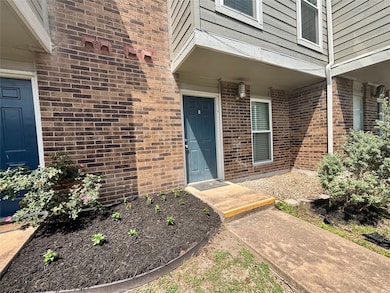 Property entrance featuring brick siding