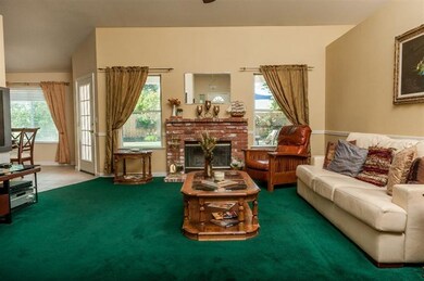 LIVING ROOM WITH FIREPLACE, LOTS OF SHELVING, FAN 