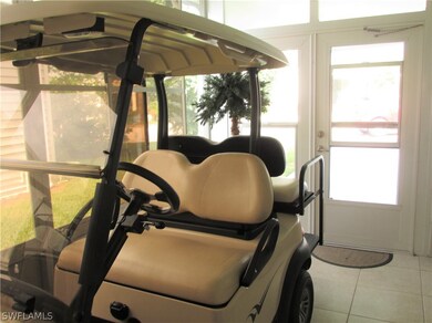 Front lanai toward carport w/double doors for cart