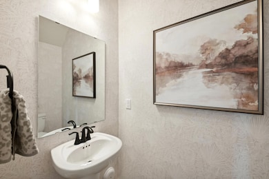 (Photo of a decorated model, actual homes colors and finishes will vary) Main level powder bath.