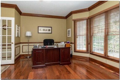 Den/Office with bay window and hardwood floors.