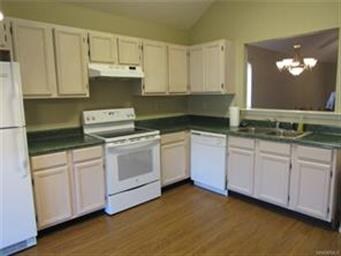 Lots of cabinets and a view into the dining and fa