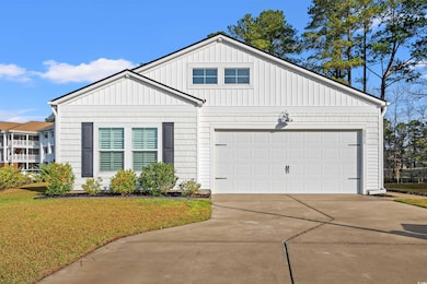 View of front of home with a garage, a front yard,