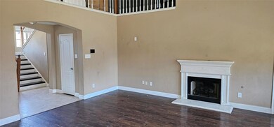 Unfurnished living room featuring hardwood / wood-