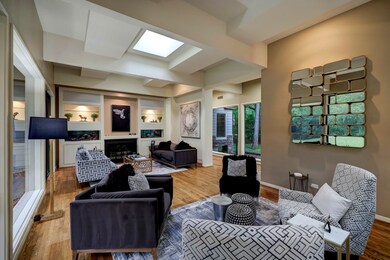 Off the entry is the formal living room, sun room, and dining room.