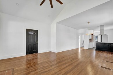 Unfurnished living room with vaulted ceiling, hard