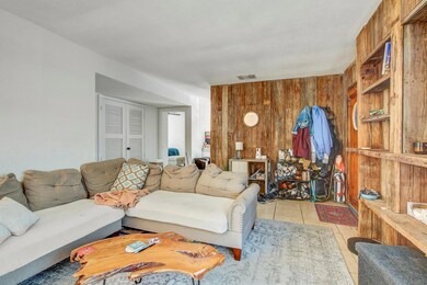 Living room with light tile patterned floors and 