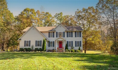 Colonial house featuring a front lawn