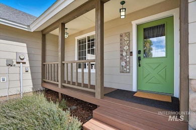 Entrance to property with a shingled roof and a porch