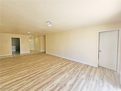 Empty room featuring light wood-style floors, base